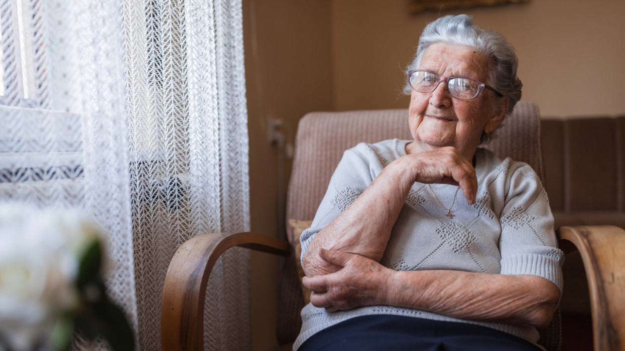 Happy mature woman wearing eyeglasses and smiling senior old pension
